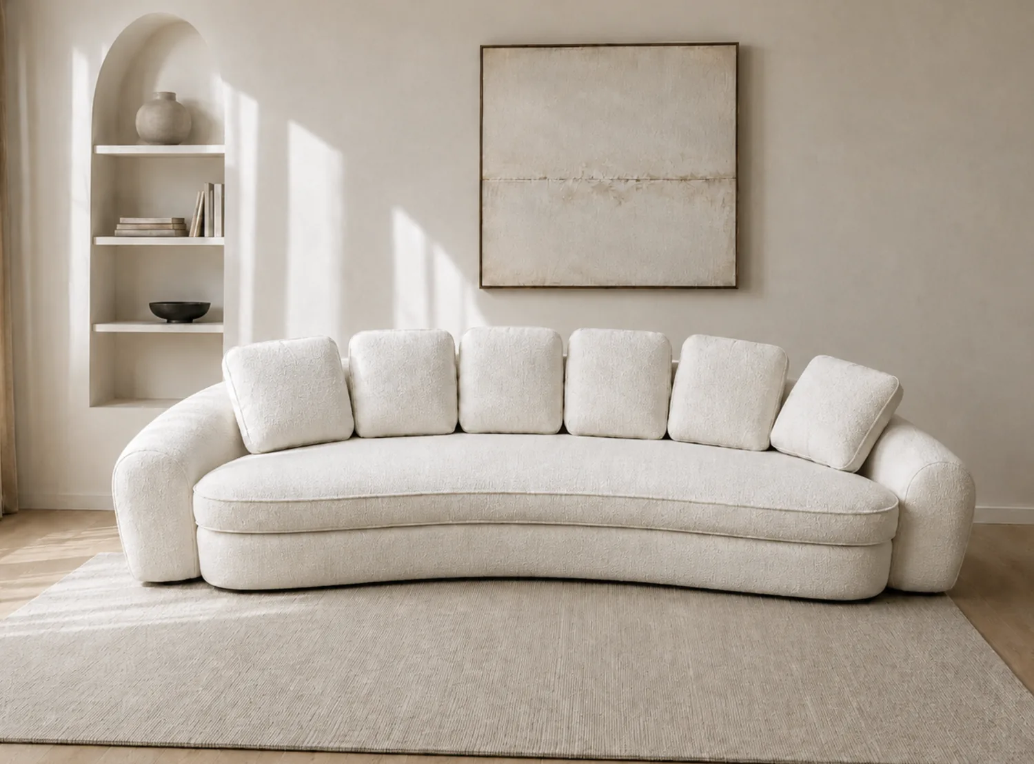 Cream bouclé sofa with a soft pillow back in an arched alcove