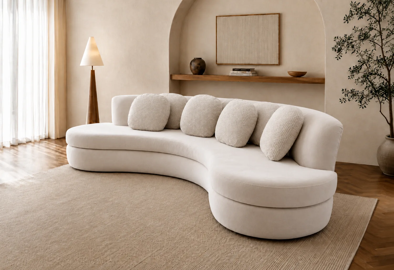 Long cream serpentine sofa with a row of bolster cushions