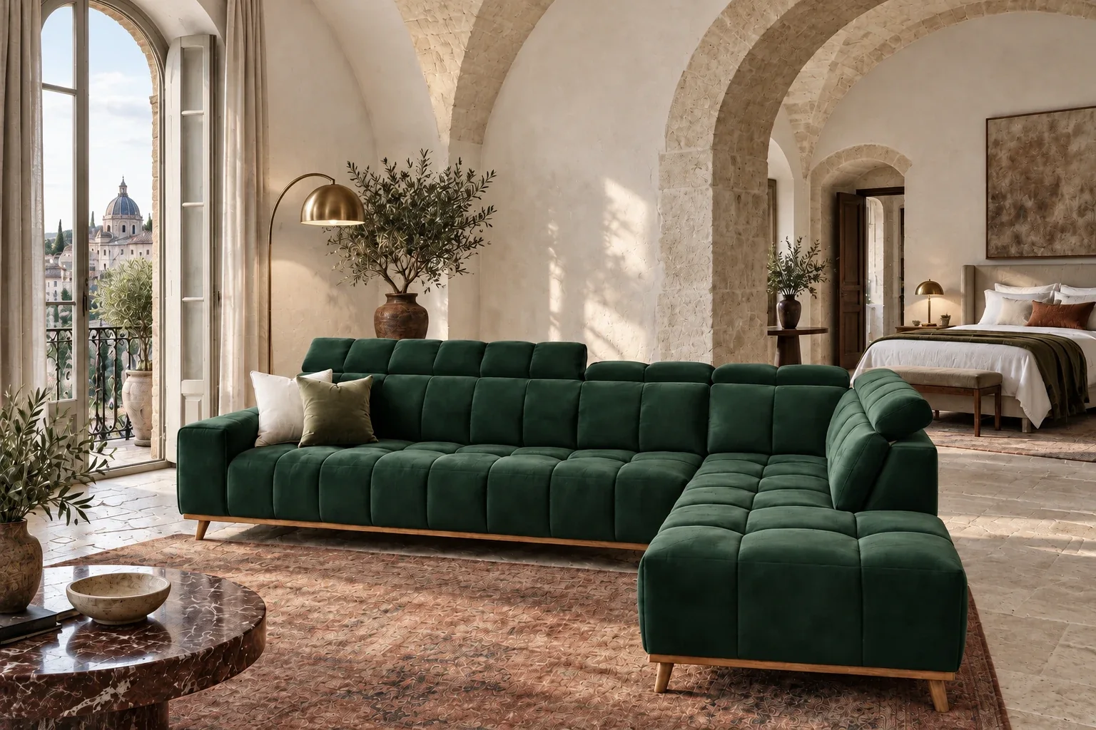 The same sofa in forest velvet, in a vaulted stone suite at golden hour