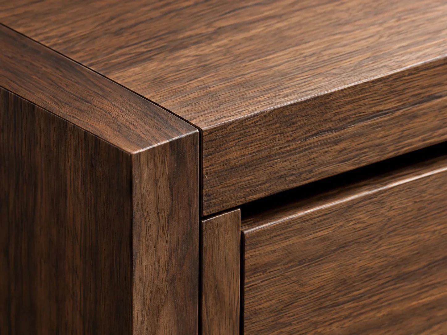 Close view of a walnut cabinet corner and its joint