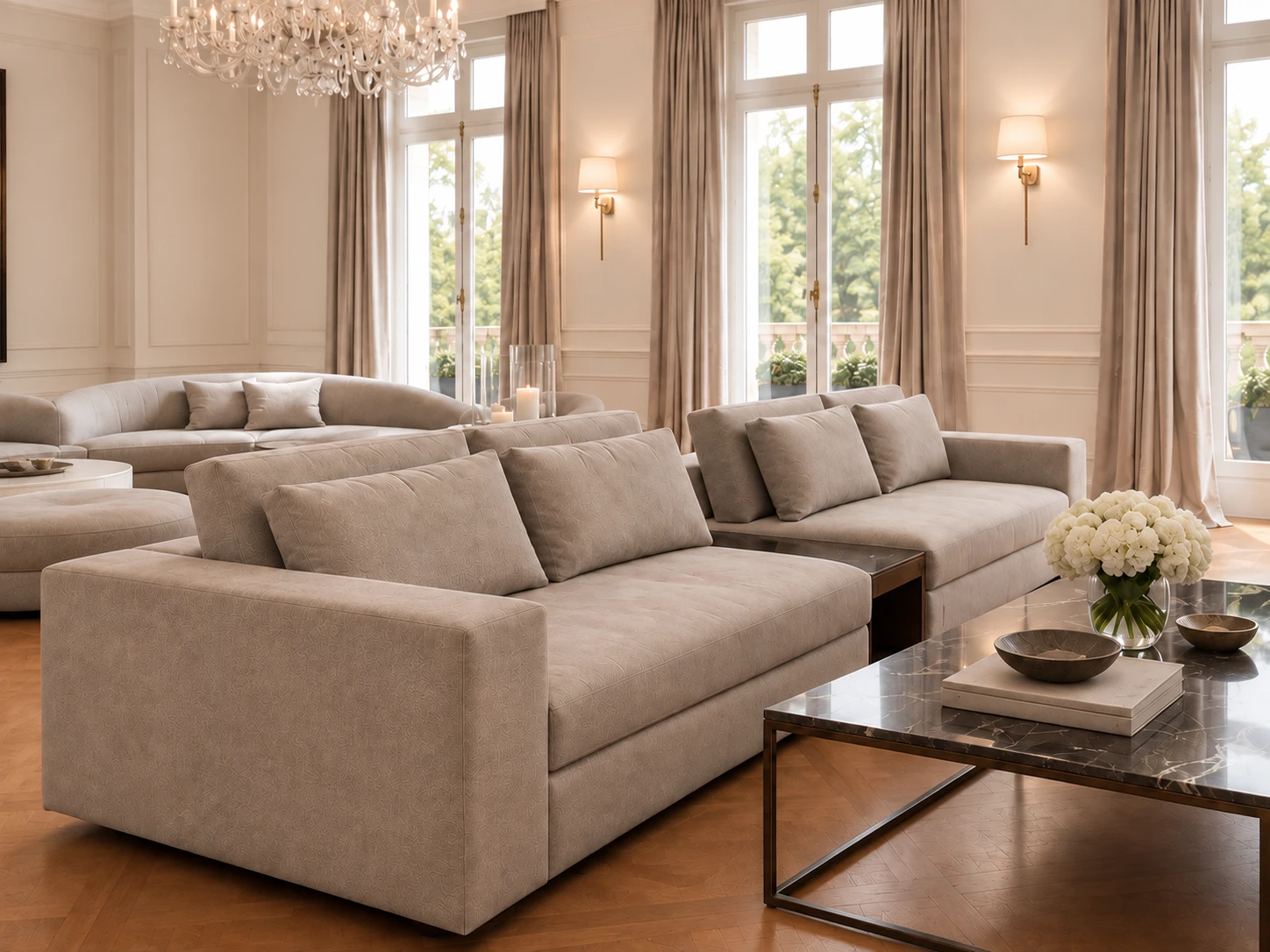 Two deep taupe sofas back to back, with a curved sofa and ottoman beyond