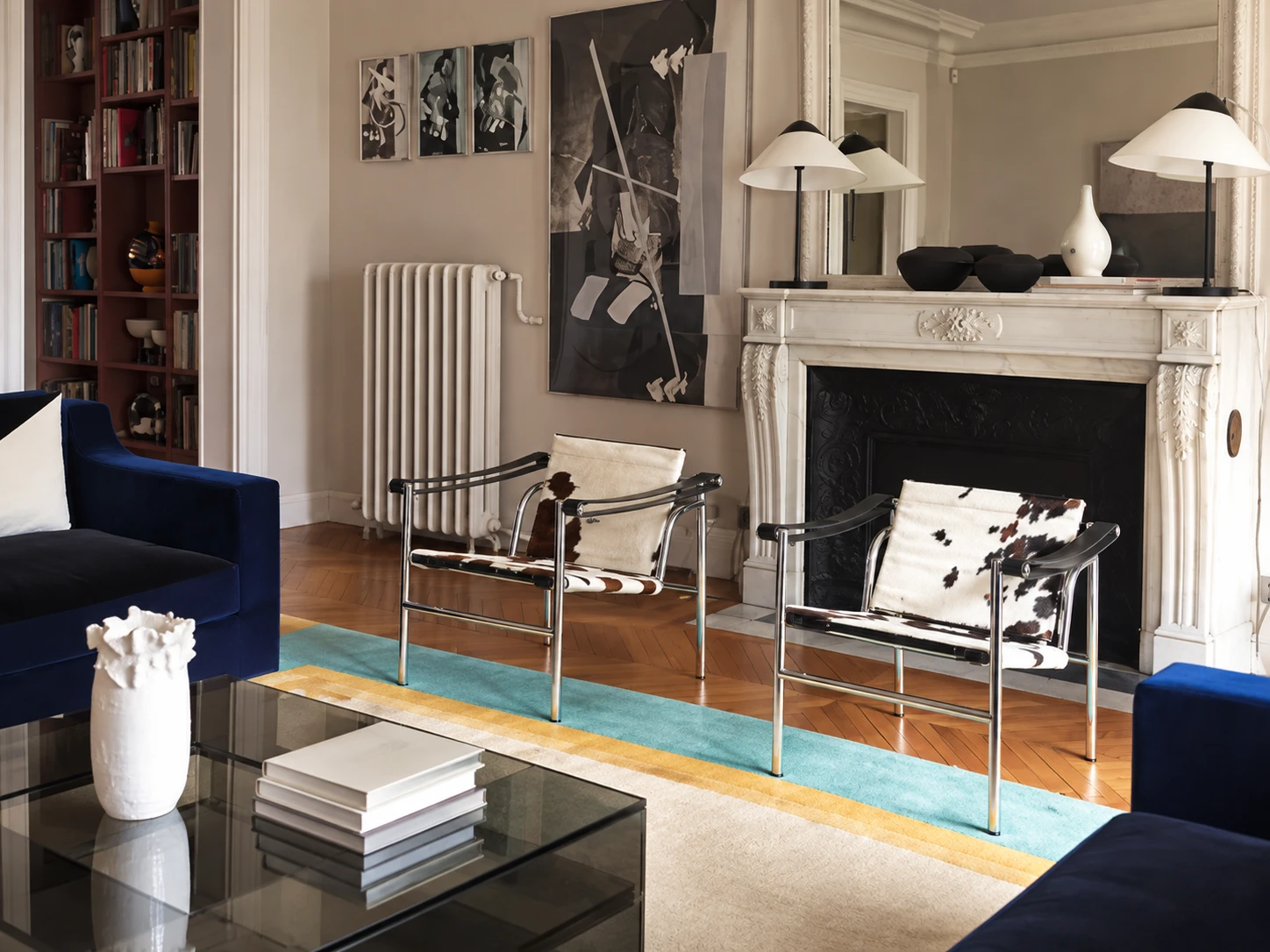 The fireplace side of the room, with the blue velvet sofas in the foreground