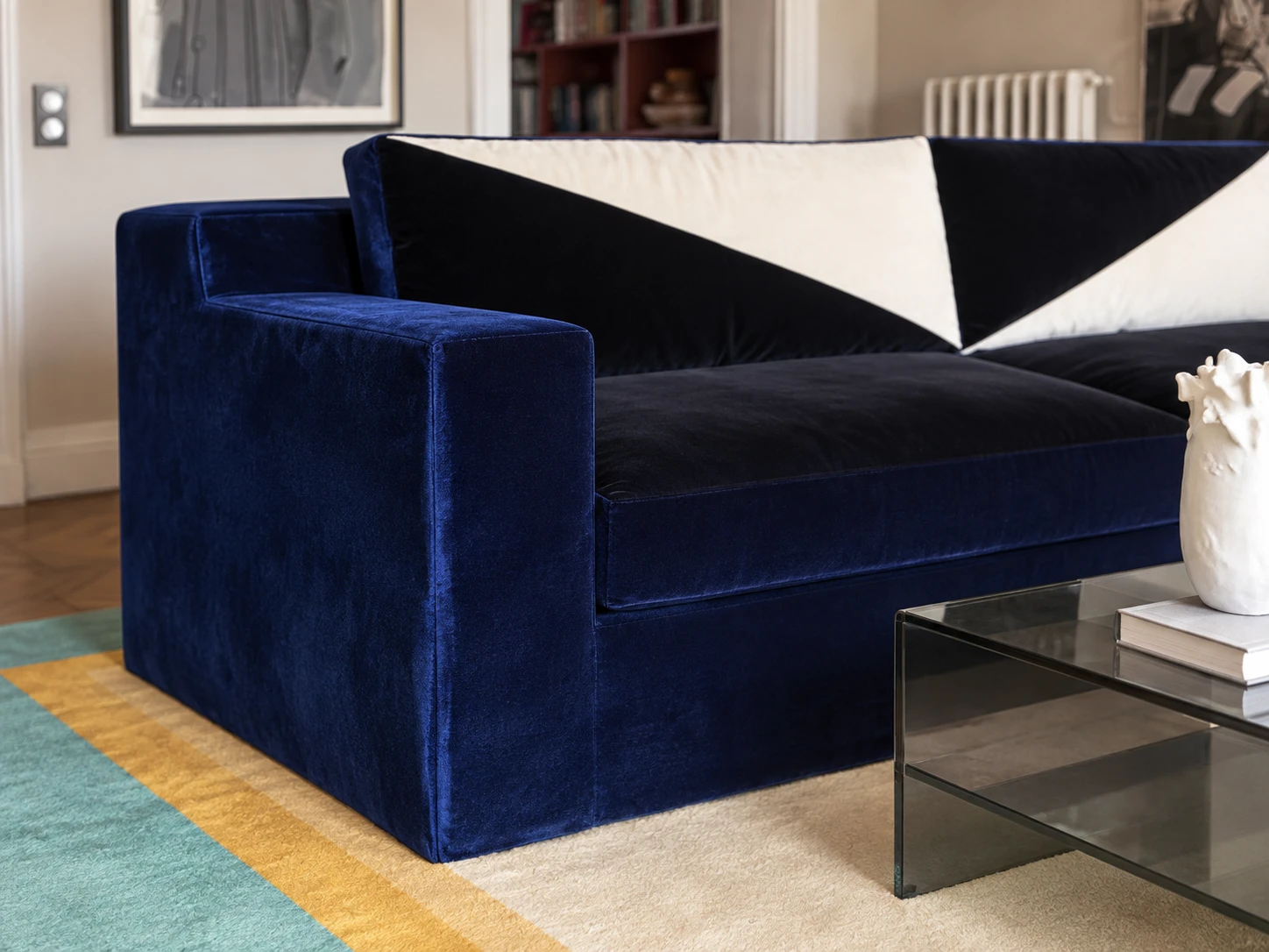 Detail of the sofa: a square velvet arm and deep seat cushion