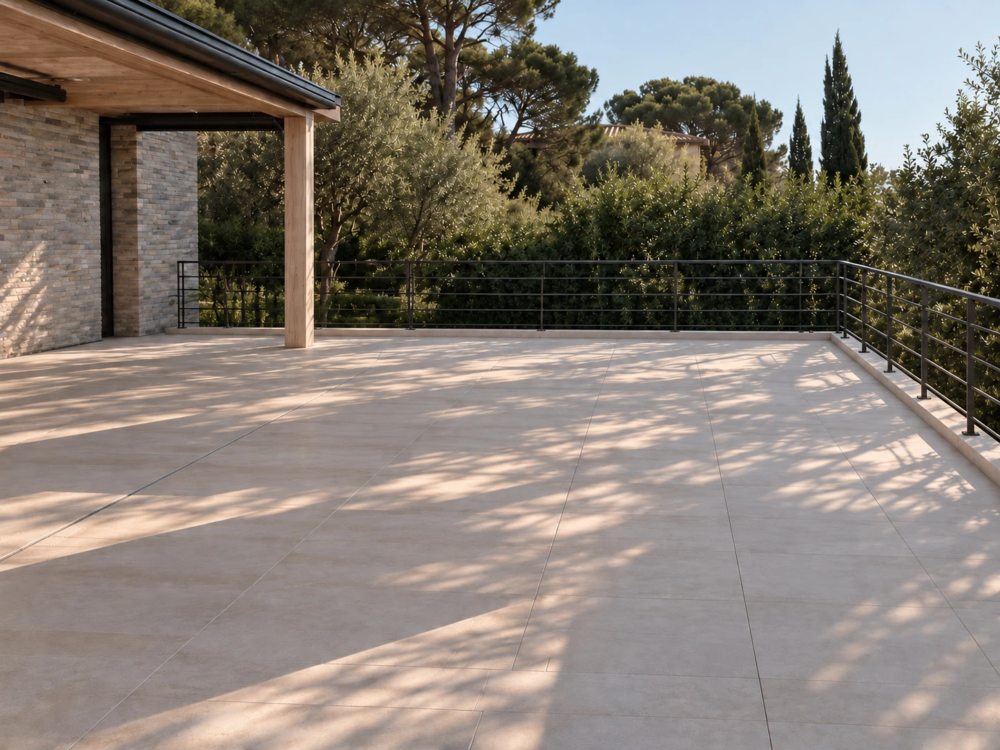 The same terrace before it was furnished: bare stone paving in dappled evening light